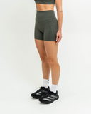 Side profile of high-rise performance shorts with pocket seam detail