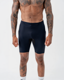 Front view of a man wearing the black Nexletica Men's Perform Running Tights, showing the compression fit and 9-inch length