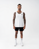 Full-length front view of a man in the white Nexletica Men's Perform Running Singlet with black shorts, white socks and running shoes