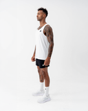 Full-length side view of the white Nexletica Men's Perform Running Singlet styled with black shorts and running shoes