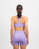 Back view of lilac training set with Nexletica Impulse High Waist Shorts and racerback sports bra on model