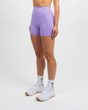 Side view of lilac Impulse High Waist Shorts 5 inch on model showing sculpted high rise waistband