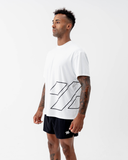 Side view of the black Nexletica Perform Hybrid Oversized T-Shirt, showing the drop-shoulder oversized fit and wrap-around logo graphic