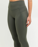 Close-up of Nexletica side logo on Synergy Leggings in Khaki